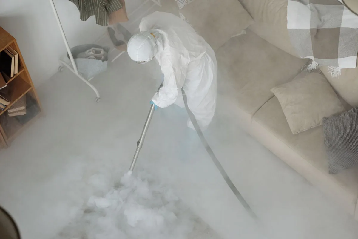 Biohazard cleanup technician in protective equipment, Upton, MA